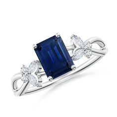 a blue sapphire and diamond ring with two diamonds on the shoulders, set in white gold