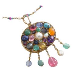 Multi Gems cabochon, Mother of Pearl and small diamond on Gold Pendant chain Necklace. Emerald, Sapphire, Ruby, Turquoise Matrix, Amethyst, Pearl, Opal, Citrine, Peridot, Garnet, Diamond. Mid 20th Century. Size of the pendant: Total height: 2.95 inches (7.50 centimeters) including bail. Total width: 1.77 inch (4.50 centimeters). Chain length: 24.80 inches (63.00 centimeters). Total weight pendant and chain: 38.64 grams. Former property of a French Lady. Luxury Multicolor Briolette Necklaces, Luxury Multicolor Briolette Necklace, Elegant Multicolor Cabochon Gemstones, Yellow Gold Multi-stone Cabochons For Fine Jewelry, Yellow Gold Multi-stone Cabochons Fine Jewelry, Luxury Multicolor Briolette Jewelry, Exquisite Oval Jewel Necklaces, Exquisite Multi-stone Round Necklace, Exquisite Multi-stone Necklace