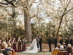 a bride and groom are standing in front of the wedding party at their outdoor ceremony