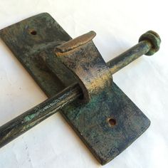 a close up of a metal object on a white surface