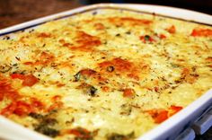 a casserole dish with cheese and vegetables in it