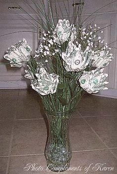 a vase filled with white flowers on top of a tile floor