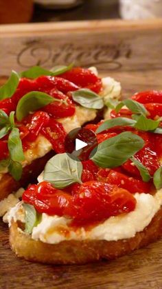 a piece of bread with tomatoes and basil on it