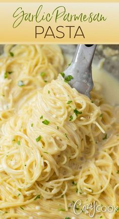 pasta with parmesan cheese and parsley in a white sauce on a plate