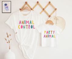 two t - shirts that say animal control, party animal and are hanging on a wall