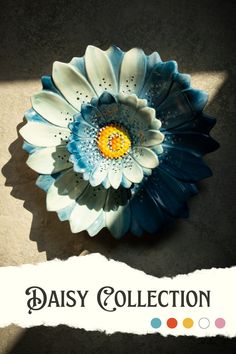 a blue and white flower sitting on top of a table