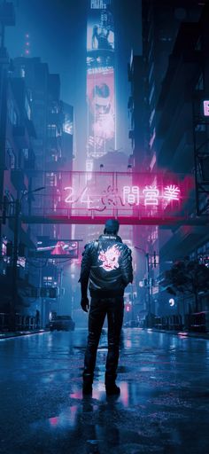 a man standing in the middle of a city at night with neon signs above him