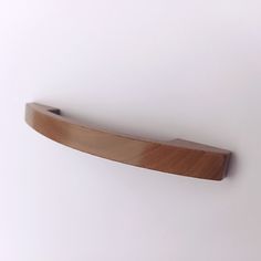 a close up of a wooden object on a white surface