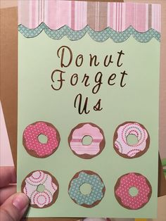 a hand holding up a card with doughnuts on it that says, donut forget us