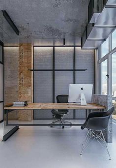 an office area with a desk, chair and laptop on the table in front of large windows