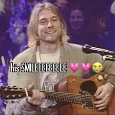 a man holding an acoustic guitar in front of a microphone with the words, his smileeeeee