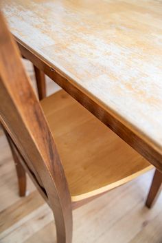 a close up of a wooden table and chair