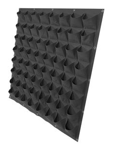 a large black wall with spikes on it