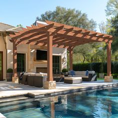 an outdoor living area next to a swimming pool