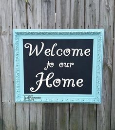 a welcome sign hanging on the side of a wooden fence that says, welcome to our home