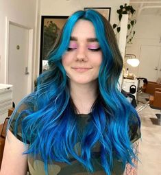 Immerse in a sea of dimensional blues with this cascading hairstyle, highlighting a stunning money piece color block for an edgy contrast. Loose waves suggest volume, while long layers keep it airy. A laid-back, striking style awaits. Dive in, explore more, and follow us on Pinterest! ** Photo Credit: Instagram @cemeterystrut Blue Balyage Long Hair, Blue Hair Front Pieces, Blue Hair With Brown Roots, Peek A Boo Blue Hair, Under Color Hair Ideas For Brunettes, Blue Money Pieces, Blue Money Piece Hair, Turquoise Blue Hair, Purple Highlights Blonde Hair