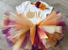 This beautiful Pumpkin inspired birthday outfit is perfect for Birthday's, Photo shoots, or just for fun to celebrate! Tutu is double layered and extra poufy made with Plum, Wine, Cream, Copper & Gold tulle and embellished with a yellow gold satin ribbon for adjustments. Bodysuit features a beautiful  ONE decal with gold leaf it is 100% cotton and glitter decal will not rub or flake off. Bodysuits are Carter's Brand and available in sizes 3M-24M. Please see size chart below for reference. Headba Fall First Birthday, Fall 1st Birthdays, Pumpkin Birthday Parties, Pumpkin 1st Birthdays, Pumpkin First Birthday, Gold Tutu, Fall Birthday Parties, One Year Birthday, Plum Wine