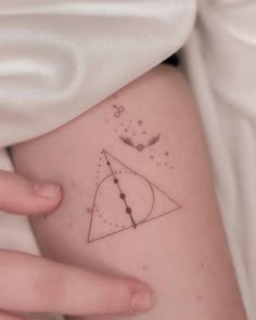 a woman's arm with a tattoo on it and an image of a clock