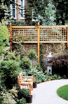 a wooden bench sitting in the middle of a garden