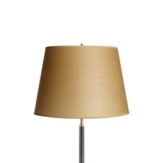 a table lamp with a beige shade on it's base and a light bulb