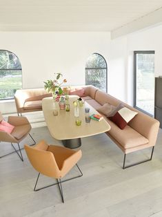 a living room filled with furniture and windows