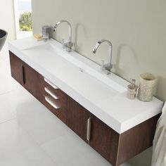 a bathroom with two sinks and a towel rack