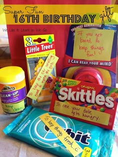 the birthday gift bag is filled with candy, snacks and other things to make it look like