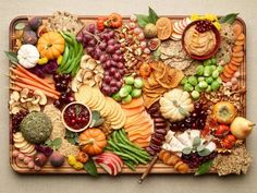 a platter filled with lots of different types of food on top of a table