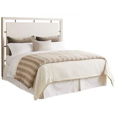 a bed with white linens and pillows on the headboard, in front of a white background