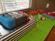 a table topped with two cakes covered in frosting and decorated with red tulips