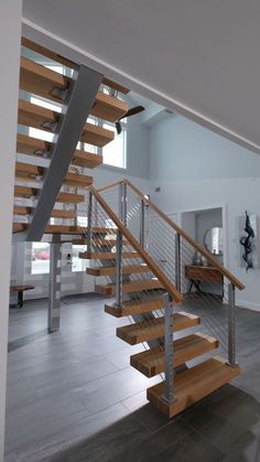 a wooden staircase with metal handrails in a house