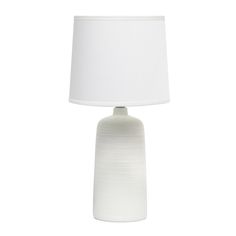 a white table lamp with a white shade on the base and a white fabric lampshade