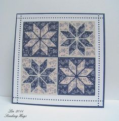 a blue and white quilted card with snowflakes on it