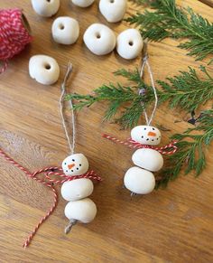 these snowman ornaments are made out of doughnuts and twined with twine