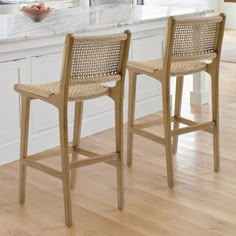 two wooden chairs sitting on top of a kitchen counter