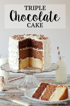 a triple chocolate cake with white frosting on a plate