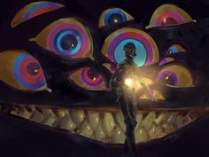 a man standing in front of a giant monster's mouth with bright lights on it