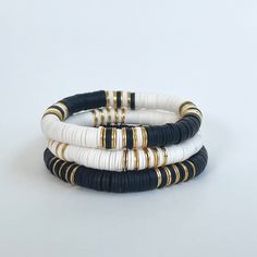 The Cruella bracelet stack will become your new daily go-to! The combination of black, white, and gold allows you to mix-and-match with so many other colors and styles.  I love to stack a few then add our Magnolia 14k gold bracelet.  Please note - each variation of the Cruella bracelet is available separately or snag them all as a set of 3!  Made with 8mm Heishi beads with gold brushed accent beads separating the color blocking 🌈Love neutrals, but looking for some color too?  🤍Our Fall/Jewel T Black White Jewelry, Heishi Bracelet Stack Ideas, Clay Bead Bracelet Ideas Black And White, Black And Gold Bracelet Stack, Black Heishi Bracelet Ideas, Fall Bracelet Stack, Neutral Bracelet Ideas, Black And Gold Beaded Bracelets, Clay Bead Bracelet Ideas Neutral Colors