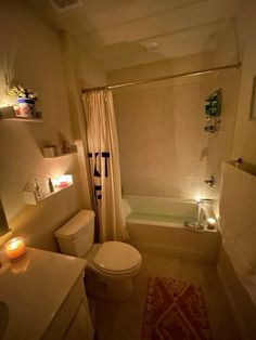 a bathroom with a tub, toilet and sink