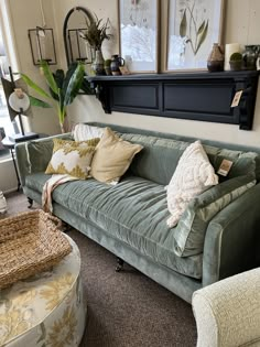 a living room filled with lots of furniture and pillows on top of it's couches