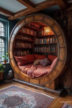 a circular bed in the middle of a room with bookshelves and windows behind it