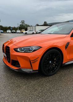 an orange sports car parked in a parking lot