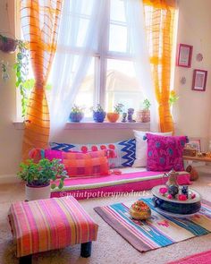 a living room filled with lots of colorful furniture and decor on top of carpeted flooring