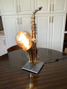 a saxophone lamp sitting on top of a wooden table