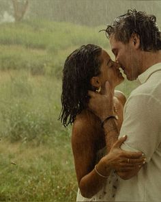 a man and woman kissing in the rain