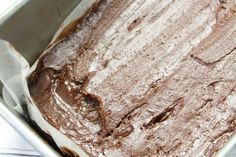 a pan filled with chocolate cake sitting on top of a table