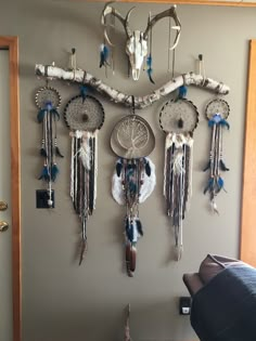 the wall is decorated with native american dream catchers and deer skull head on it