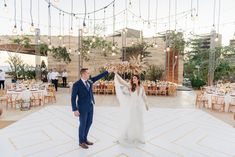 a bride and groom dancing on the dance floor at their wedding reception in an outdoor venue