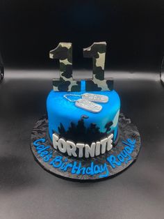 a birthday cake with camo and blue frosting for fortnite's 11th birthday party