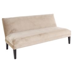 a beige couch sitting on top of a wooden frame